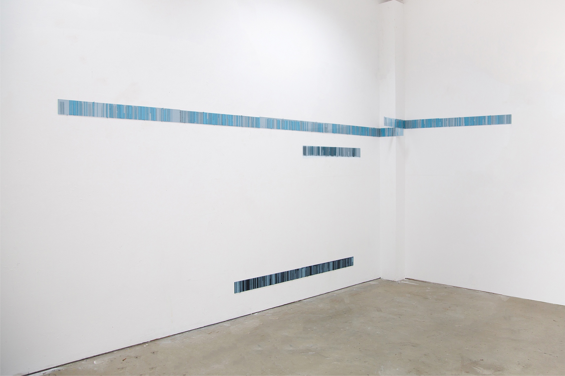 An installation comprised of long horizontal strips, bending round the architecture of the room. Each strip contains hundreds of coloured vertical stripes resembling the patterns formed by raking the salty beds of solar evaporation ponds used to harvest sa