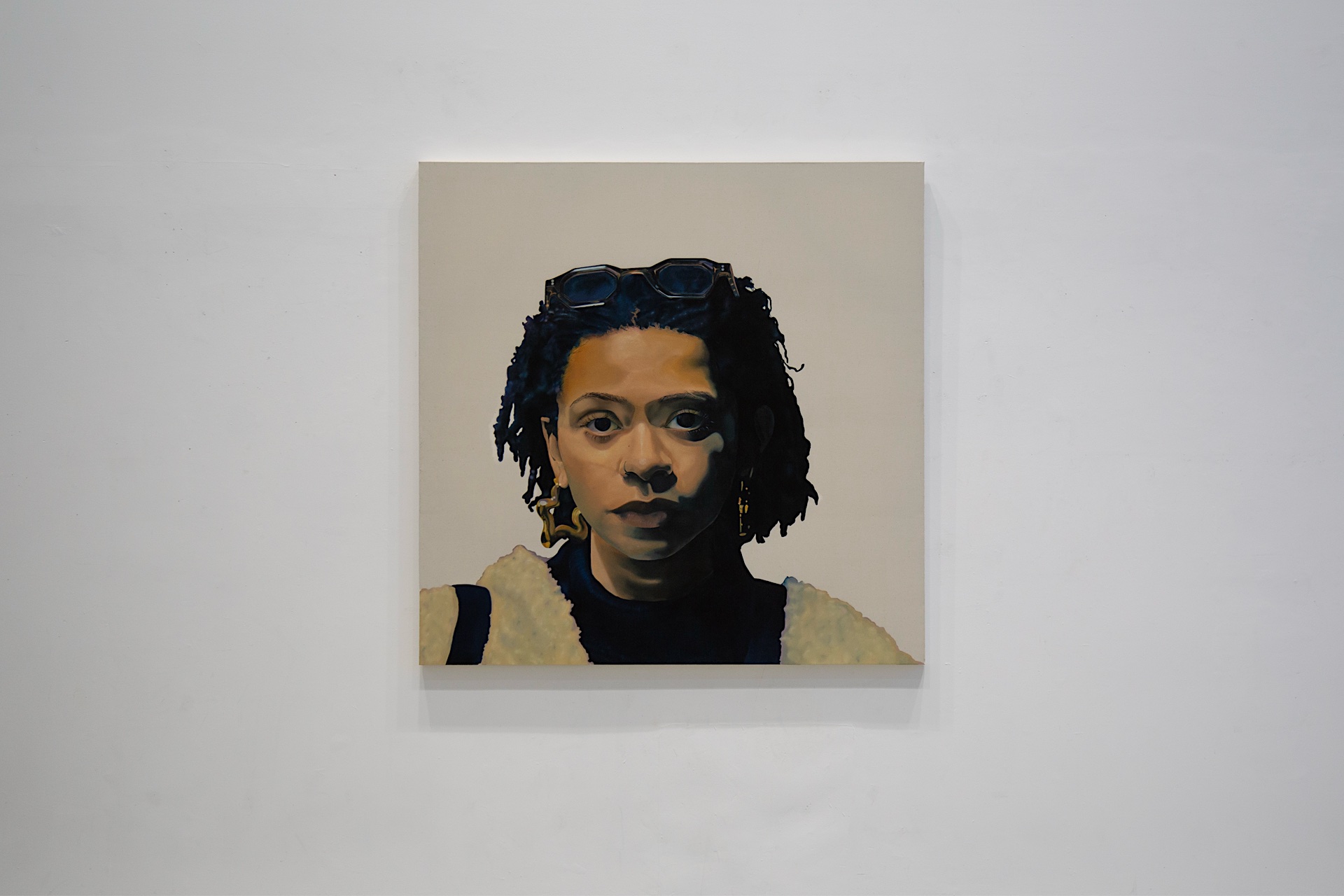 A large, background-free portrait of a person looking directly at the viewer. The lack of surrounding elements draws full attention to the subject’s expression and presence.