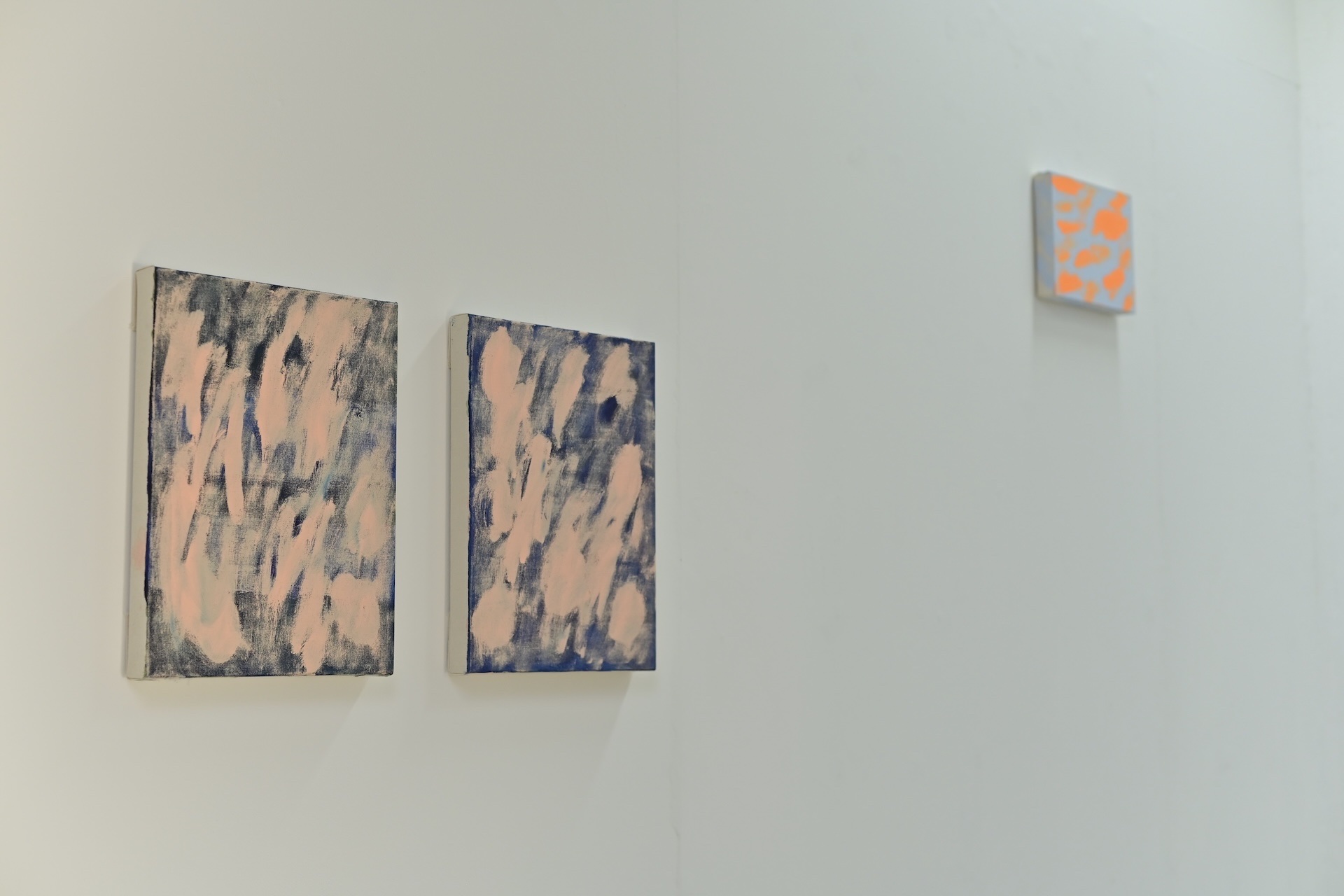 Painting with blue and soft pink horizontal bands on a white wall