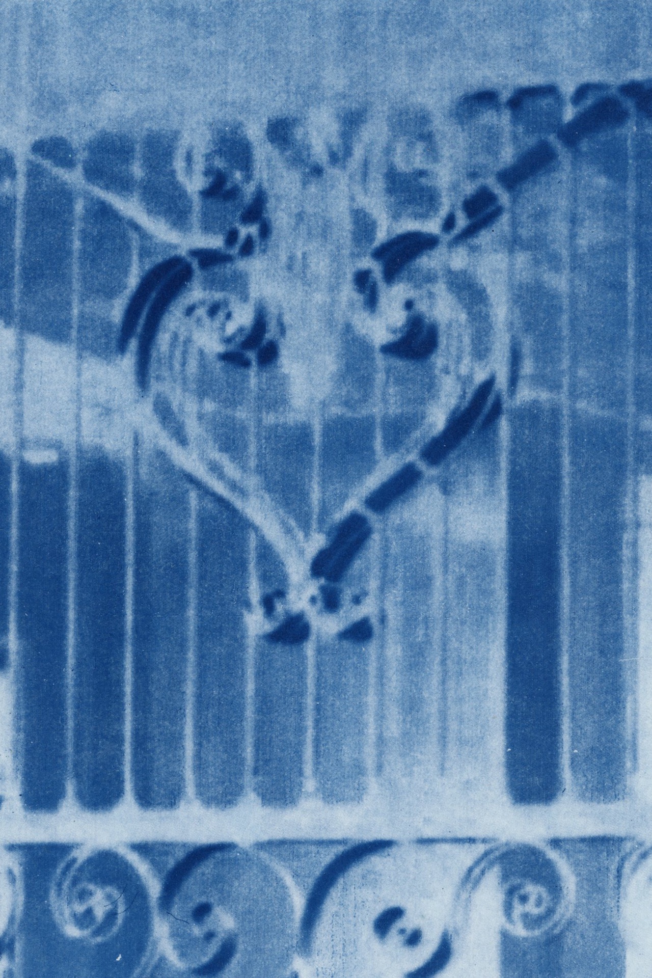 Blue print with sankofa heart on fence