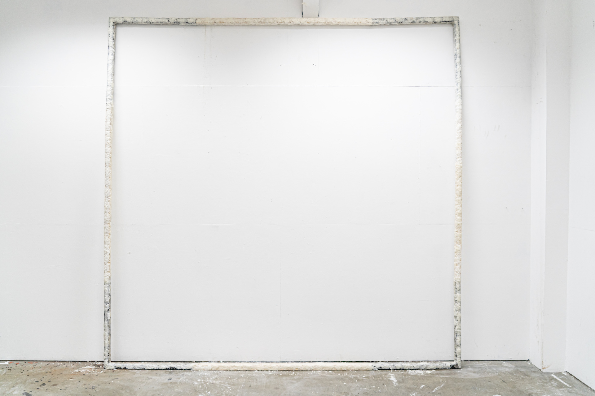 A large, 10ft x 10ft frame made from pinewood and steel, clad in grated hand soap.