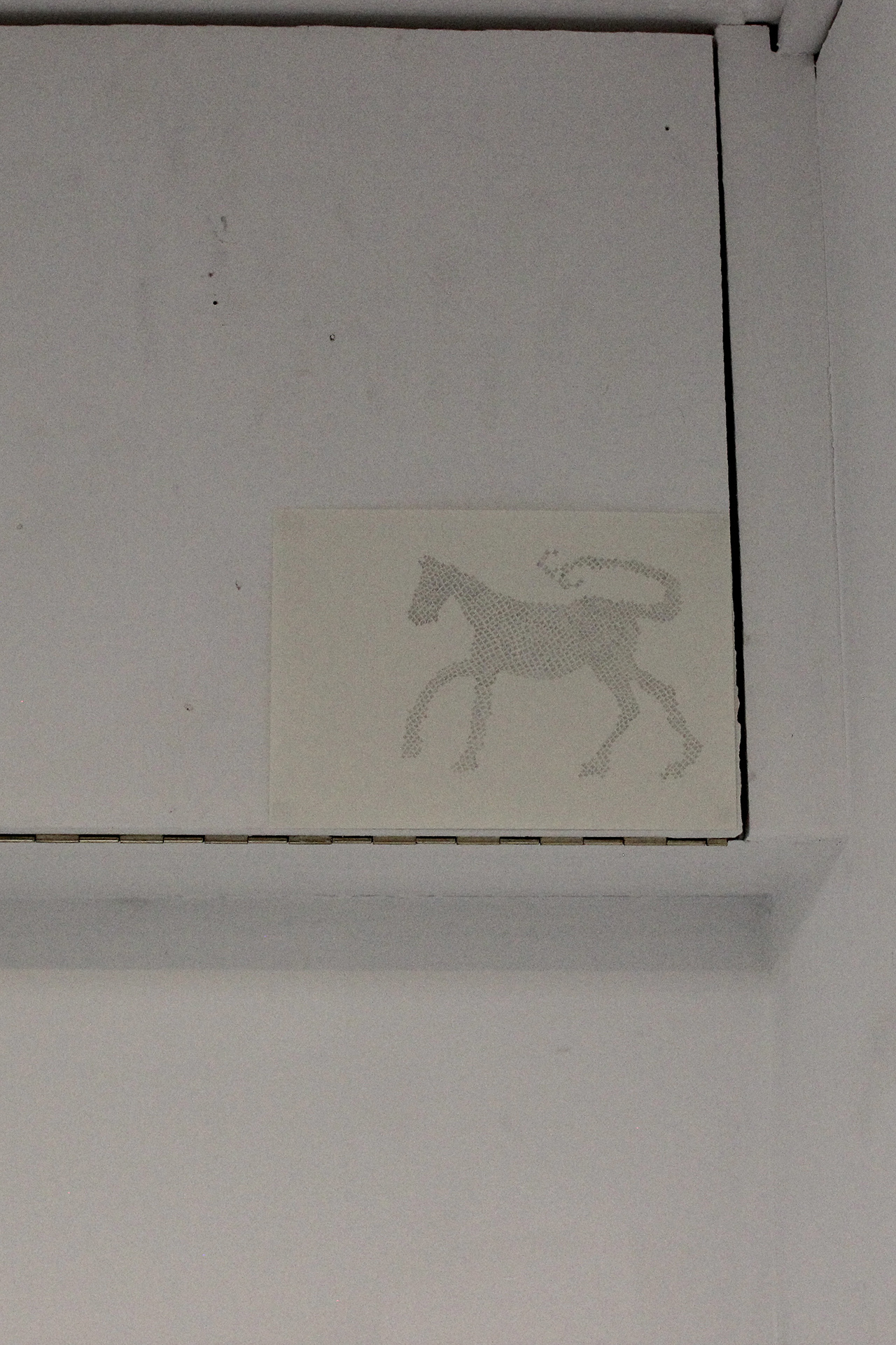 The image shows an A5 drawing of a horse-like creature, pencil on paper, that’s been installed close to the ceiling. 