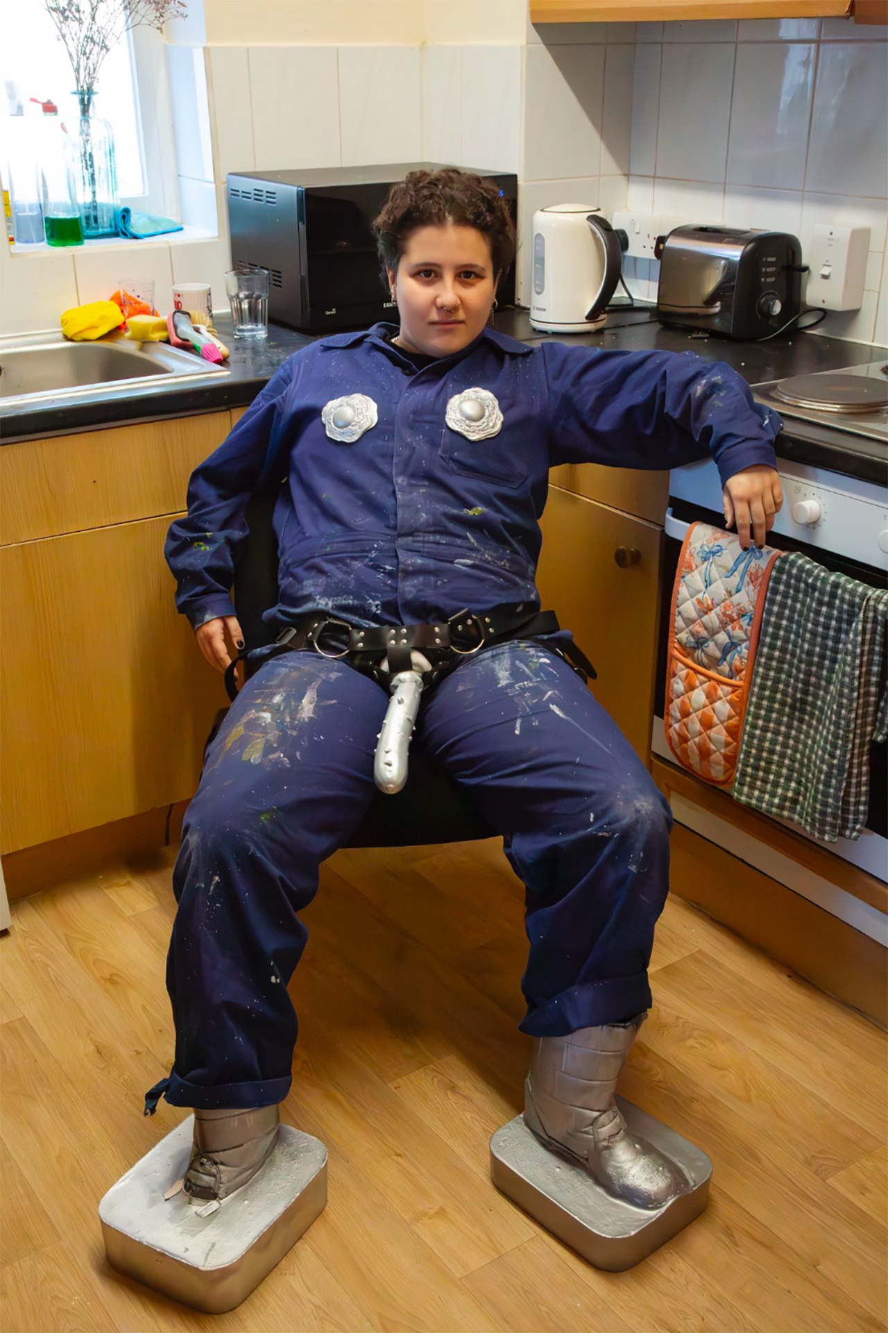 portrait with strap and boots in kitchen