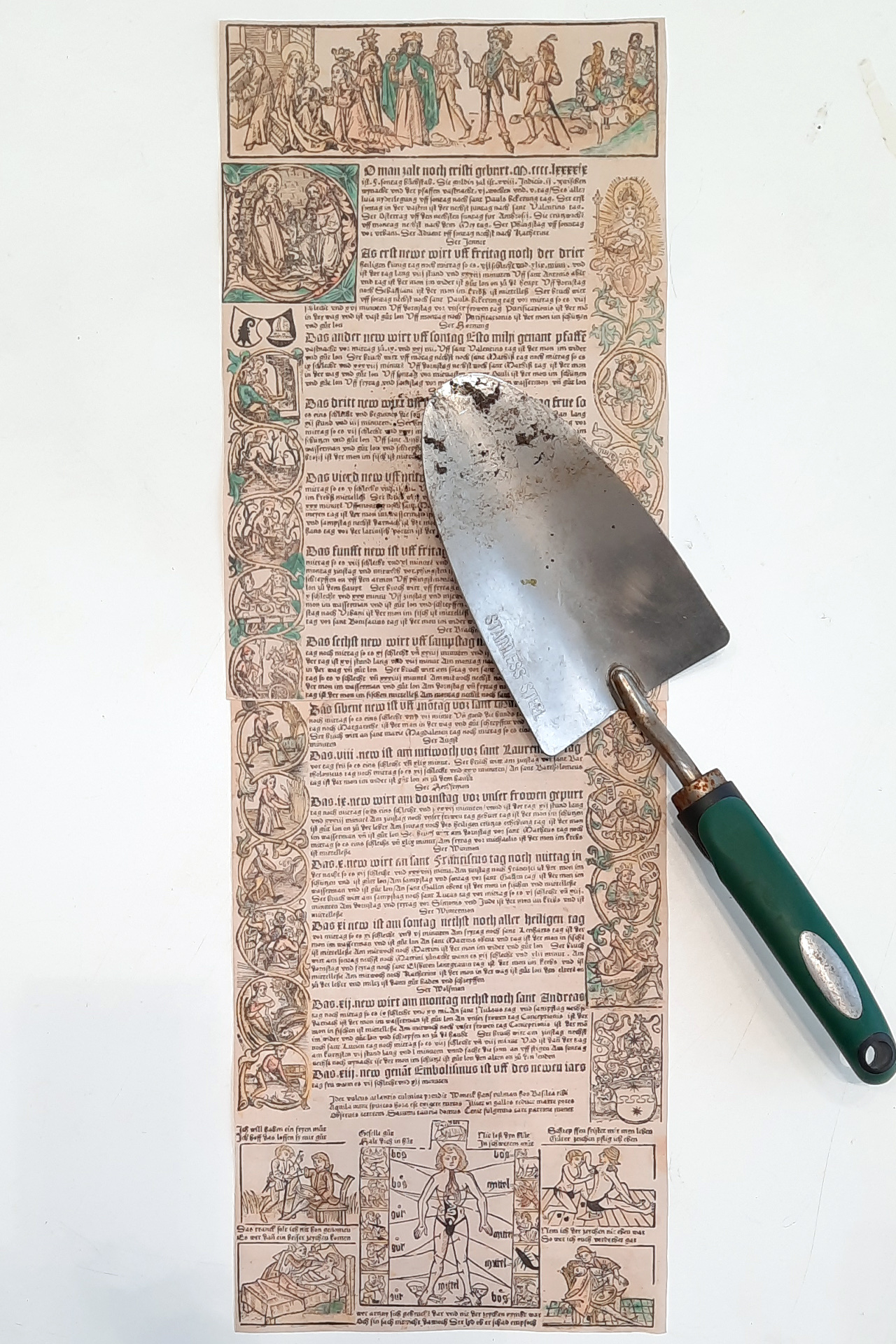 Trowel on a copy of an almanack from 1499. Woodcut illustrations of seasonal work, German lettering.