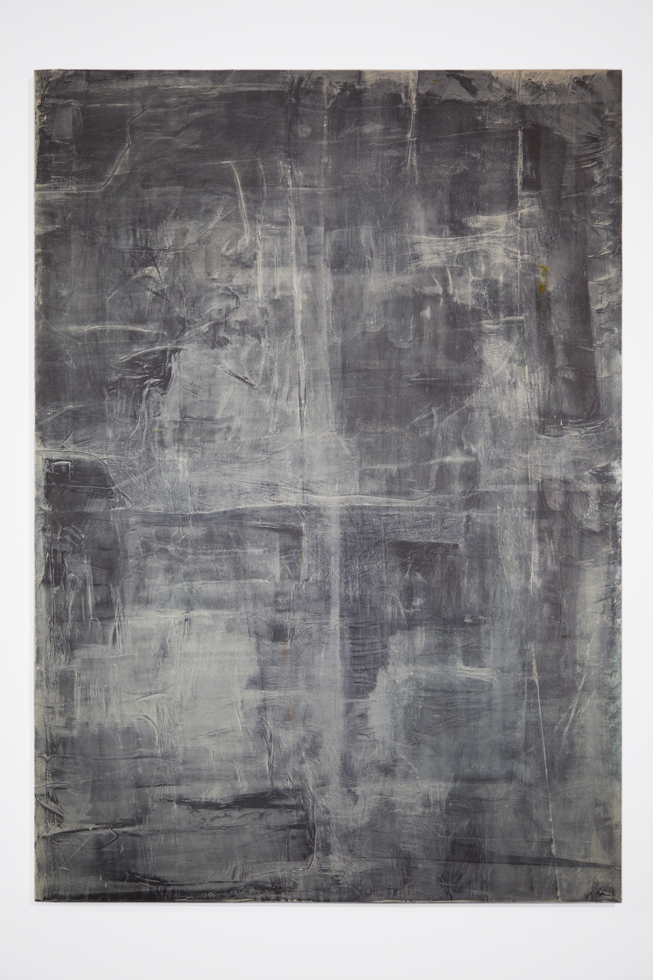 Photograph of a blue abstract painting on a white background. The painting is made up of dark and light dull blue patches.