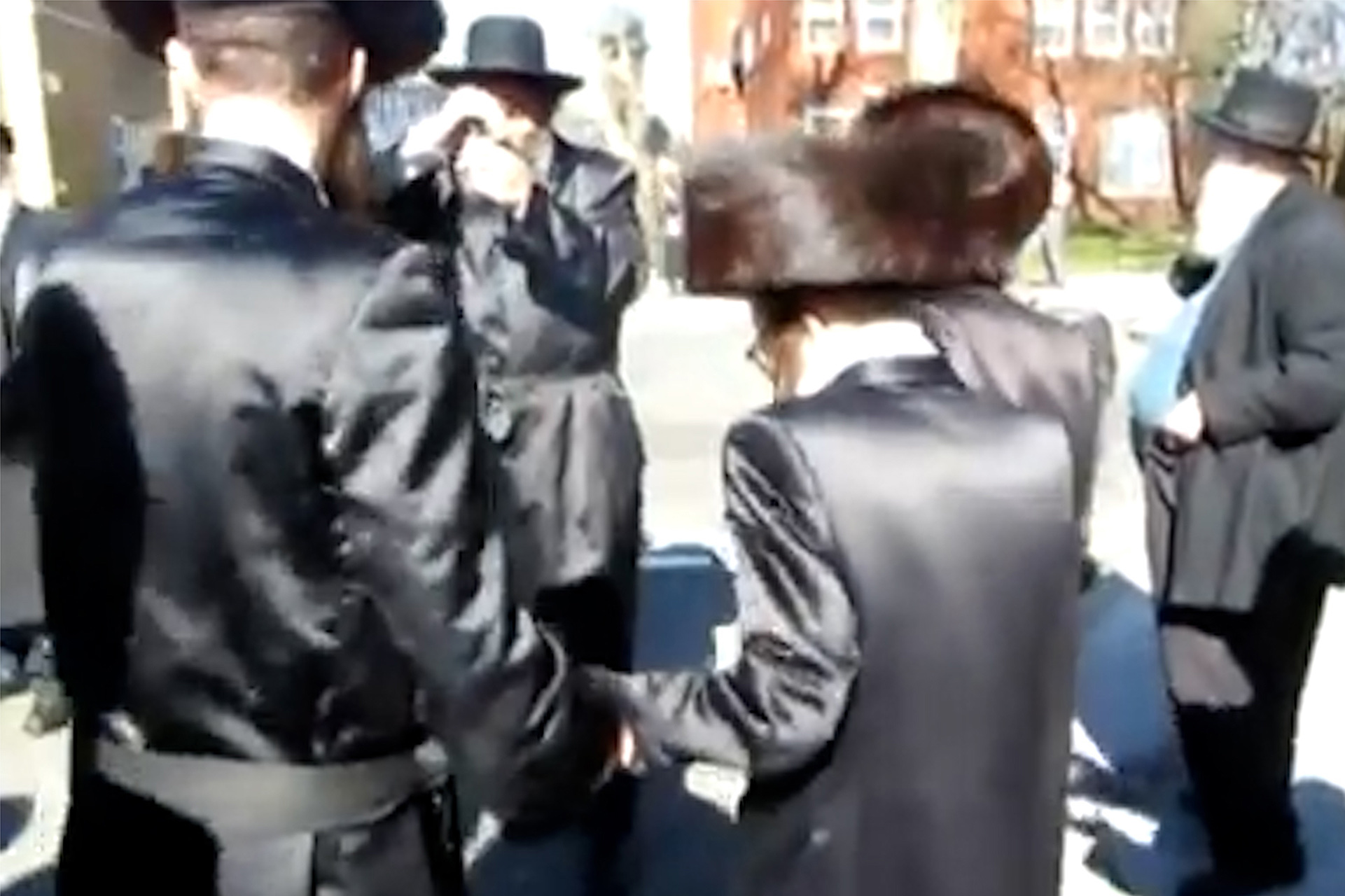 A Group of Ultra Orthodox Jews congregating in the street in London.