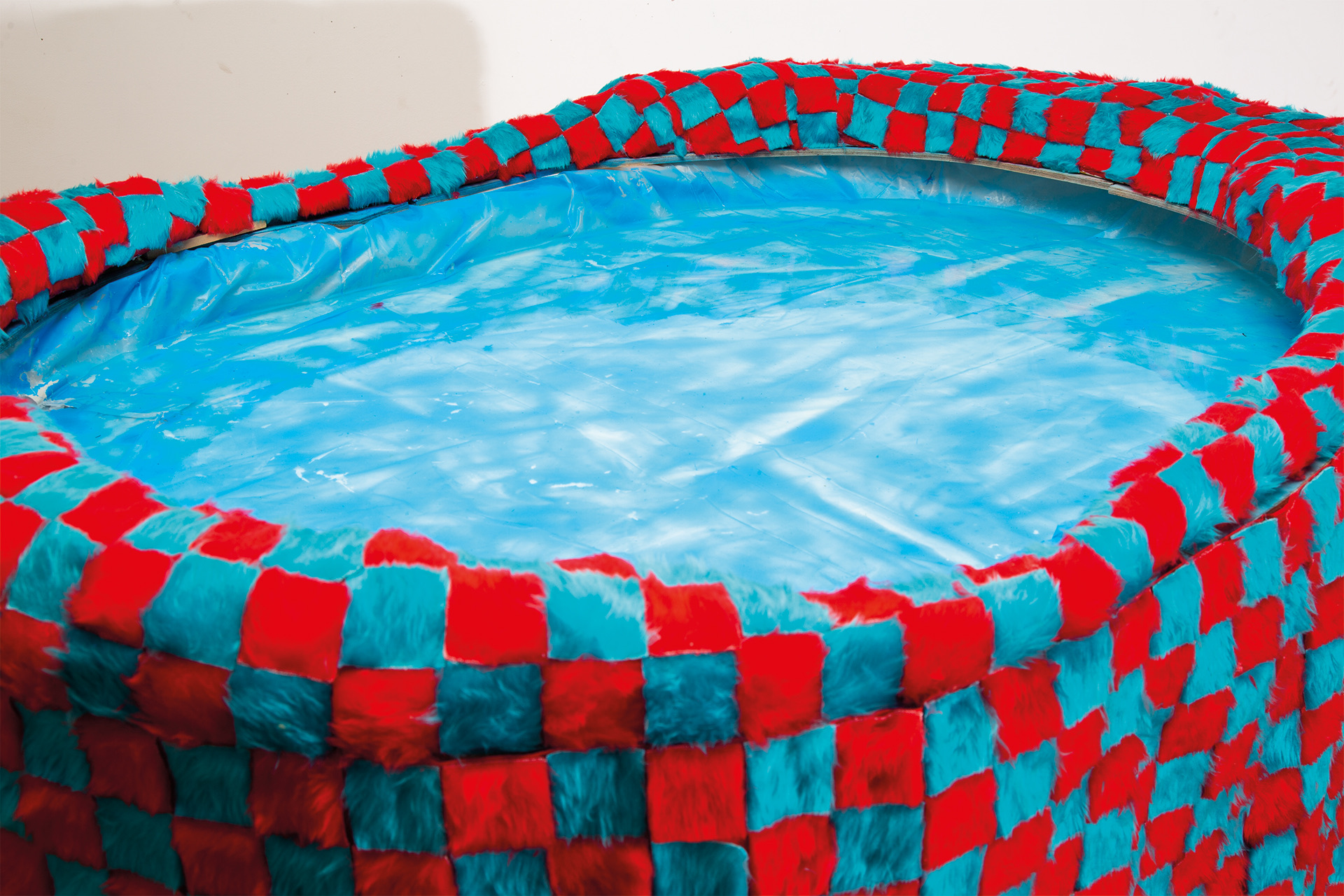 Red and blue checkerboard mouth shaped pond.