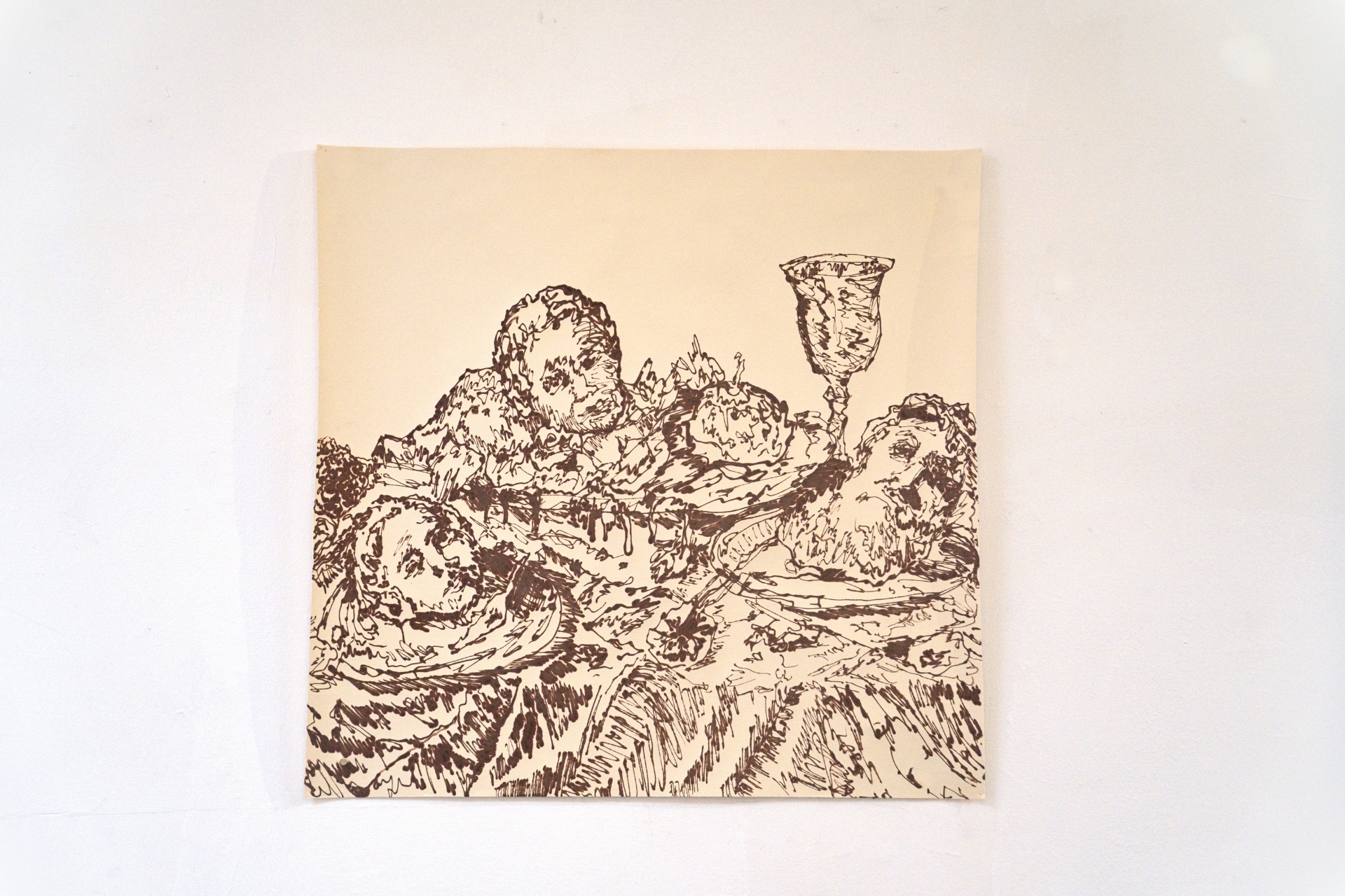 Henna drawing of human faces and a goblet amidst dense, organic strokes on a cream-colored paper.