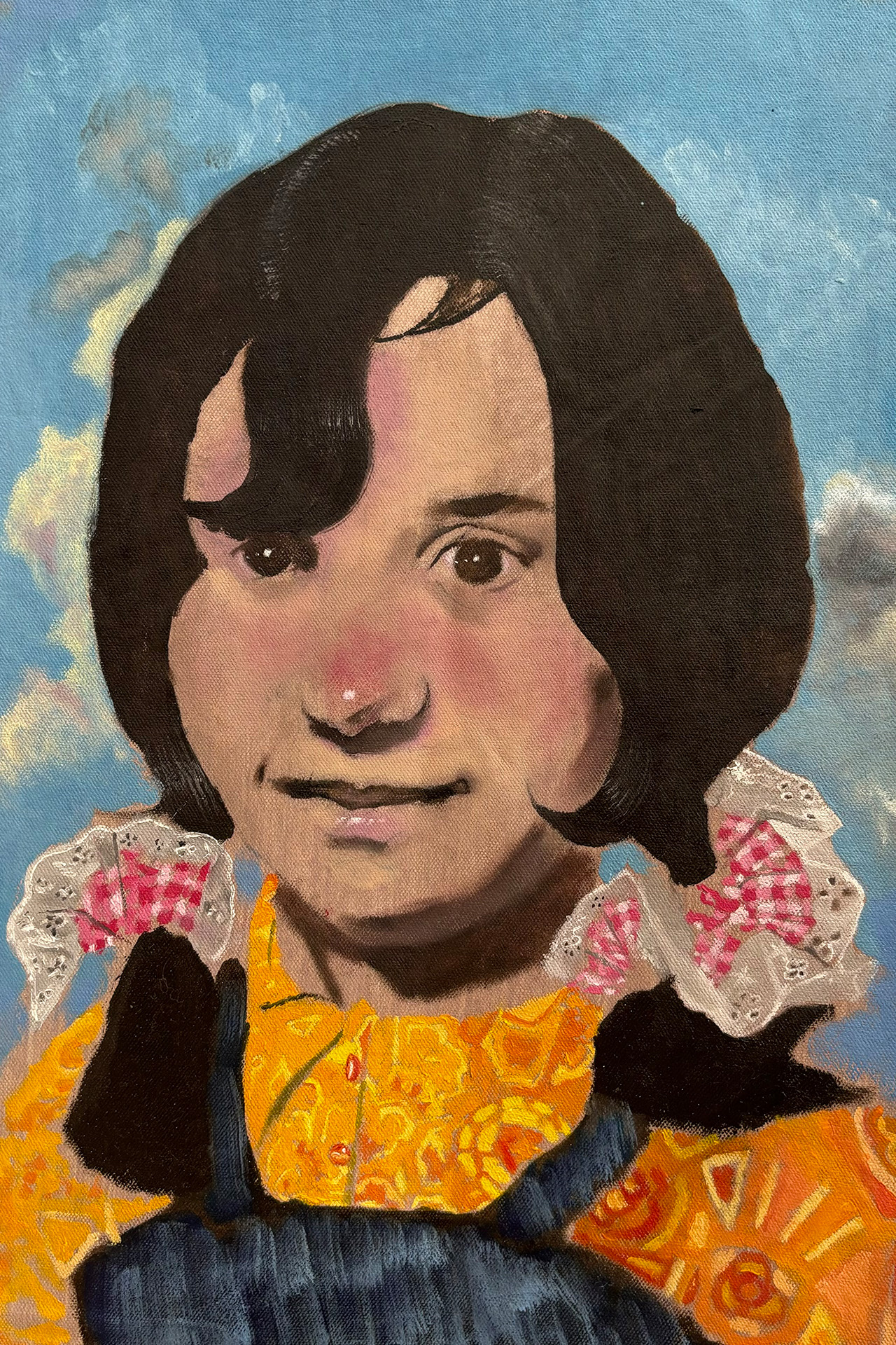 In this painting a little girl is depicted with gingham scrunchies in her brown hair. She is wearing a yellow patterned shirt and denim dungarees. The sky is bright blue in the background with white wispy clouds floating low in the sky.