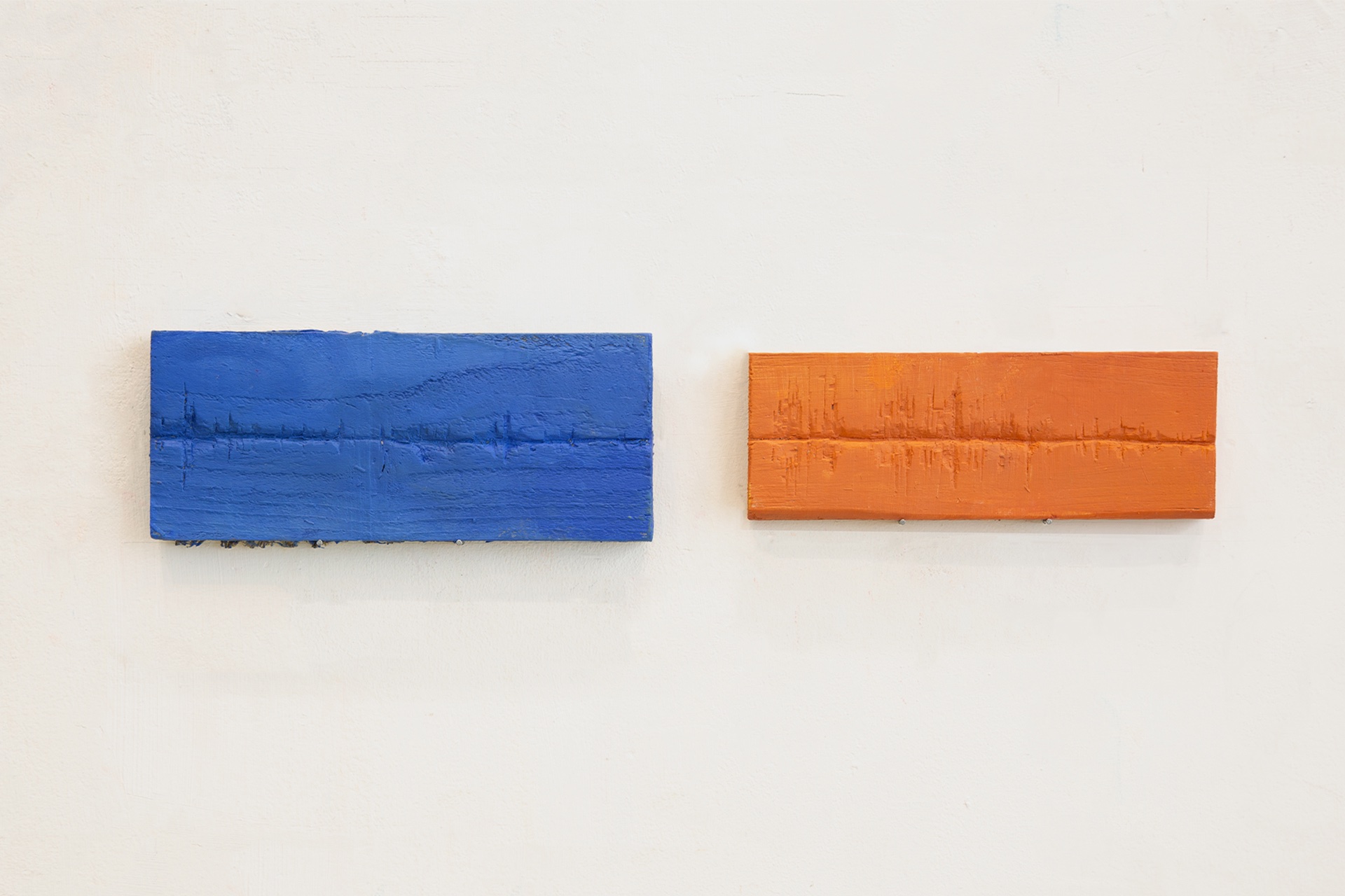 Two wood block engravings, the left is blue and the right is orange 