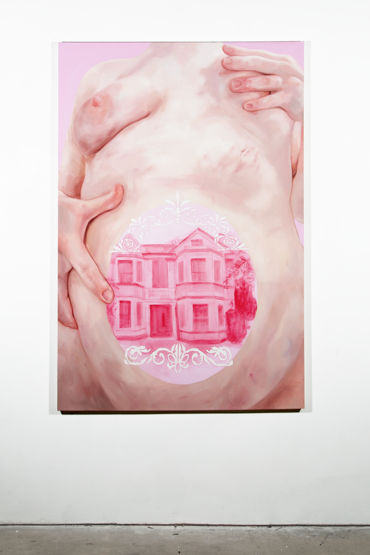 Large scale oil painting depicting a woman's torso. The belly holds a pink house inside, with ornamental details in white, framing the cut-out oval. The style is fleshy and figurative, with the house in a monochromatic vibrant rose colour. 