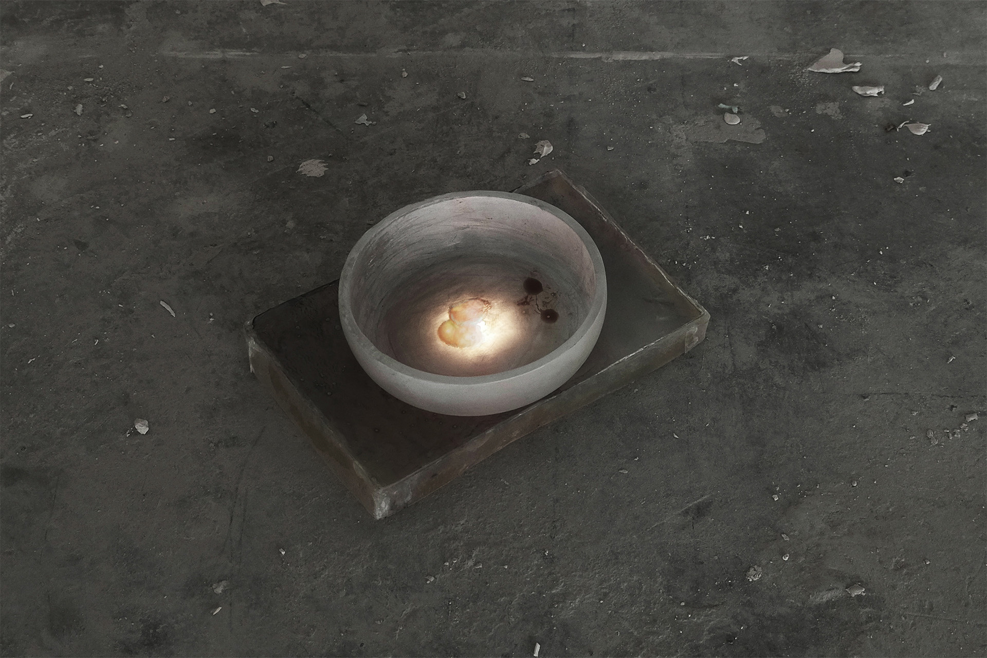 Bowl printed with an image of apples, placed on a rectangular resin block, with a light underneath.