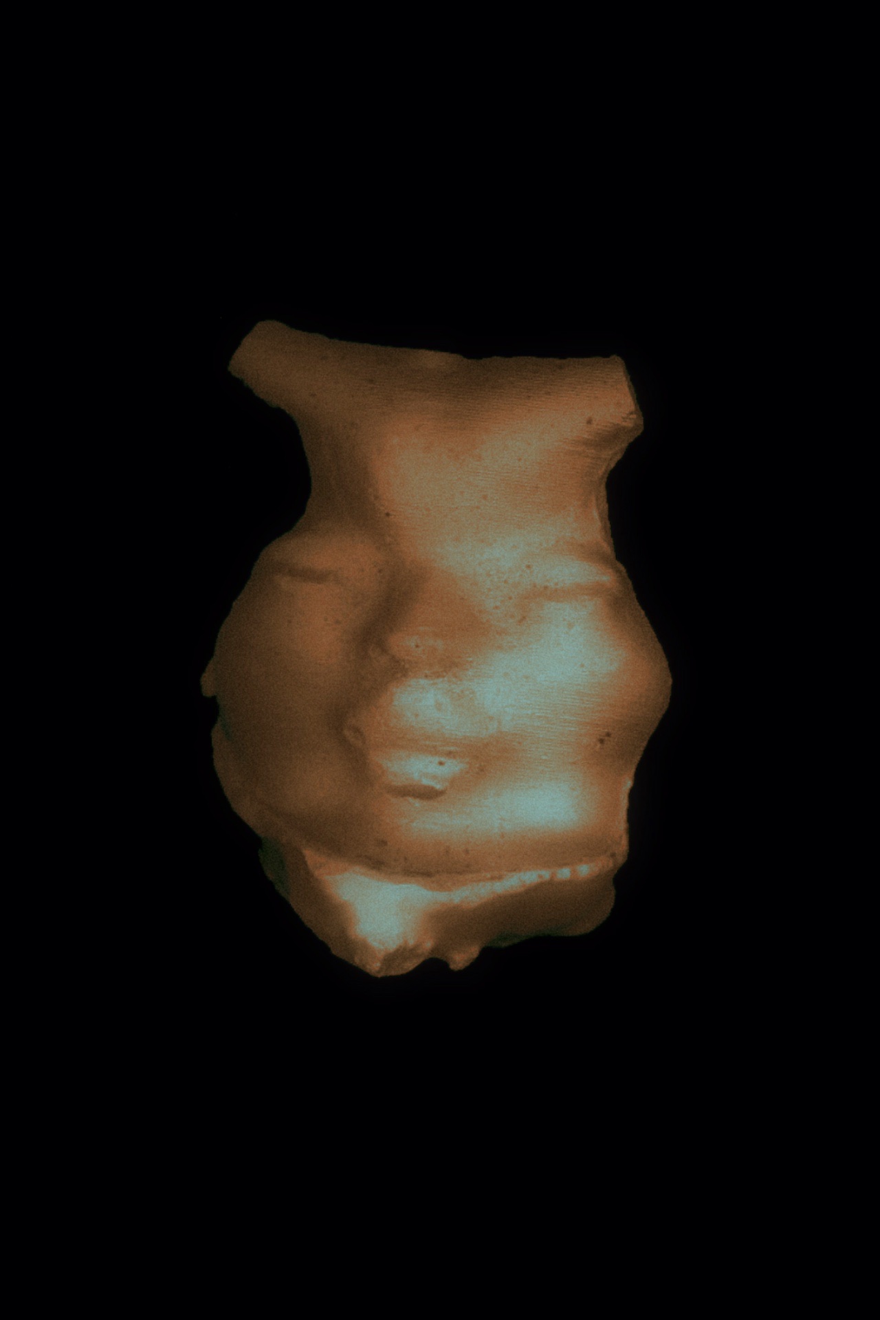 A golden face from an artefact, likely Eophis.