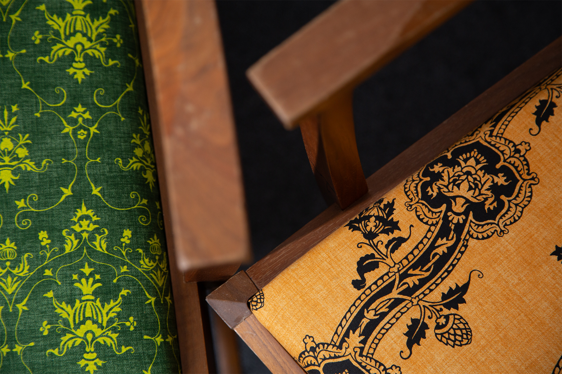 Closeup of two chairs reupholstered with screenprinted fabric.