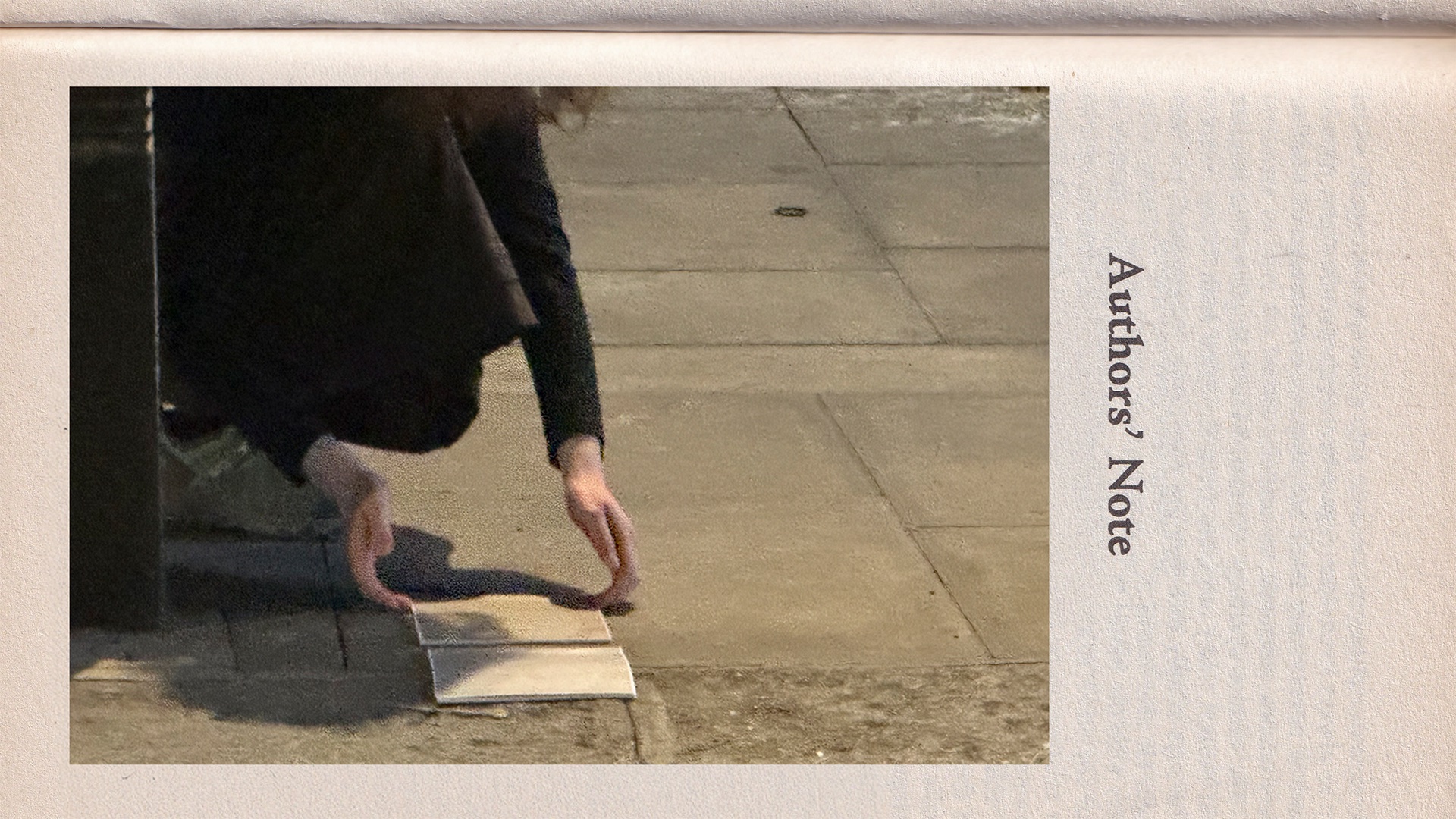 A person in dark clothing crouches on a sidewalk, carefully placing or picking up some sheets of paper. Only the arms and part of the torso are visible. The page edge aligns with the pavement line, blending text and environment. Along the right edge, “Auth