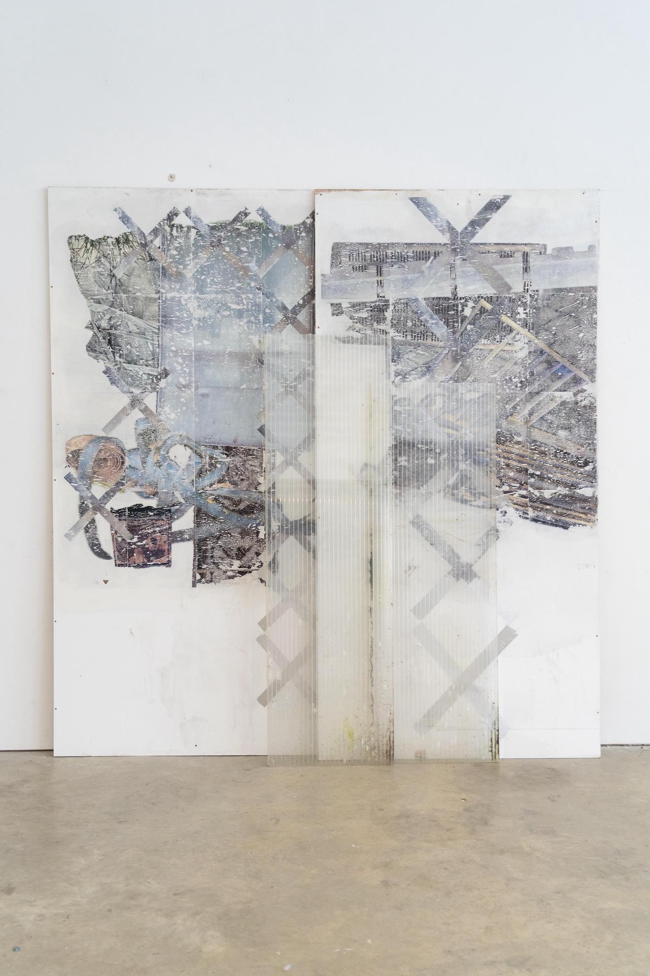 Two black glass panels bound at their edges by six off-white plastic bows hang on a white wall.
