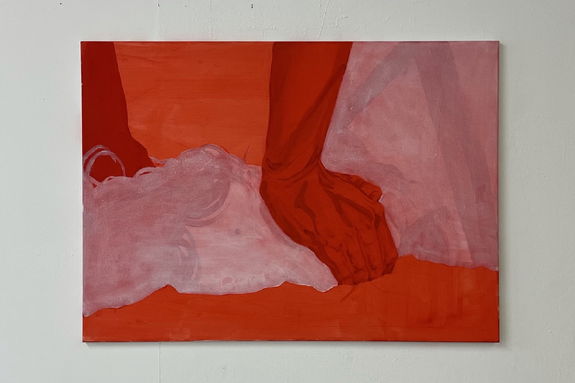 An oil painting hung on a blank white wall, depicting a bright red hand emerging from the top of the canvas smothering the mouth of a white figure laying down