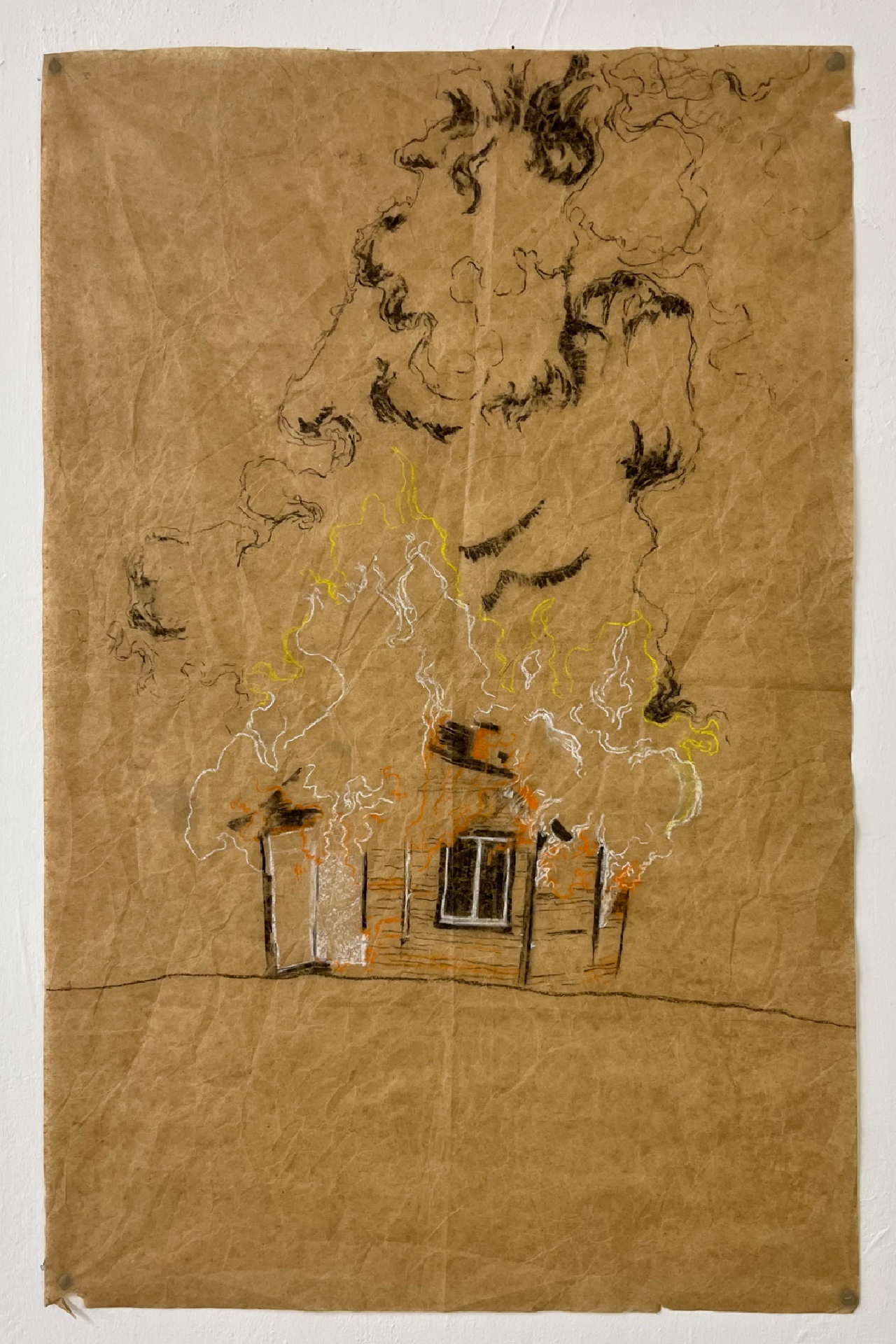 An illustration of a small wooden cabin on fire with billowing clouds of smoke, hung on a blank white wall. Drawn with charcoal, white, orange, and yellow chalk pastel on crumpled brown packing paper.