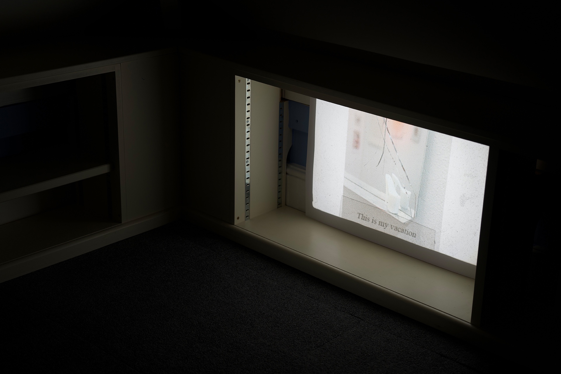 Slide projection in shelving of fictional holiday.