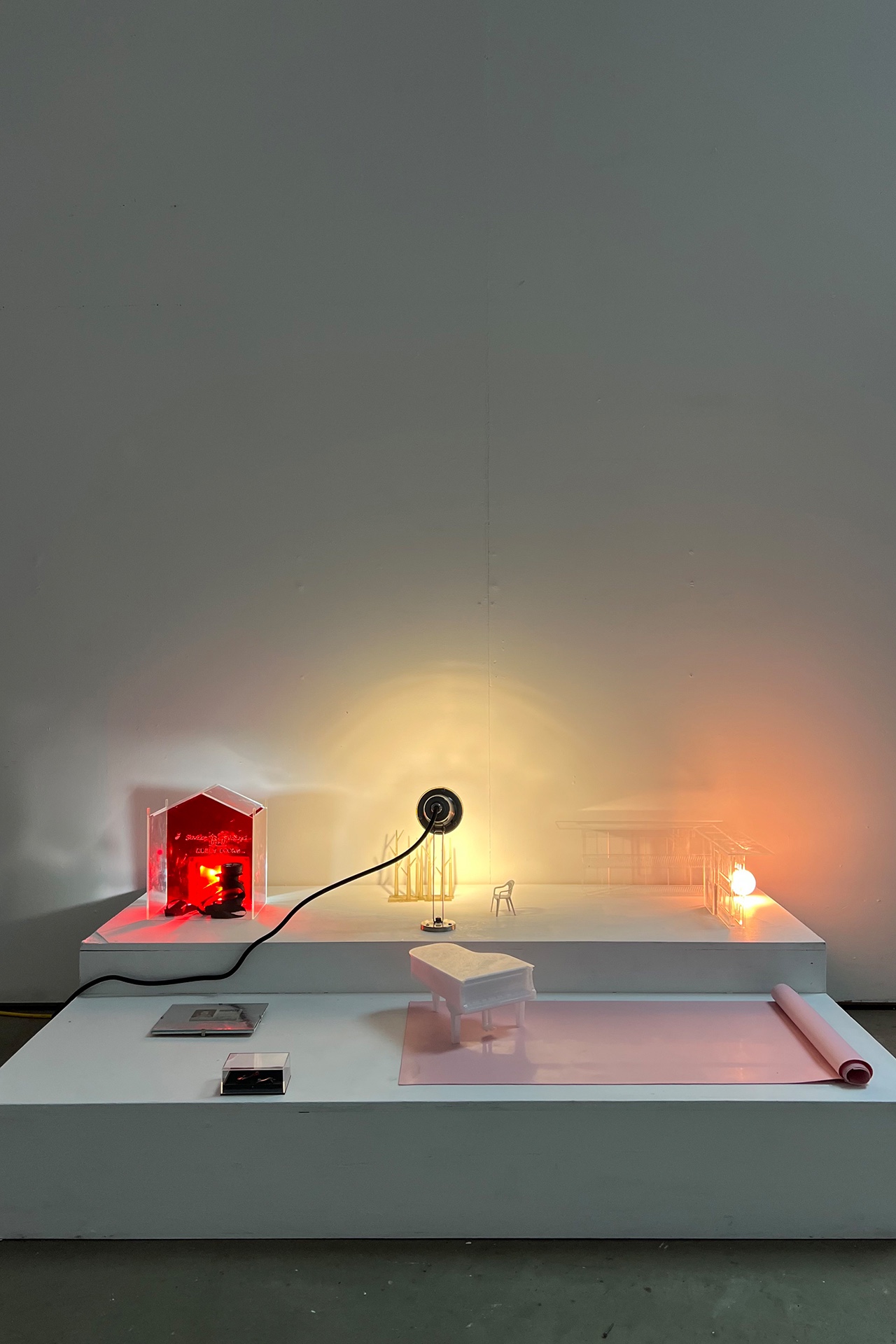Arrangement of small objects and lights on a staired plinth