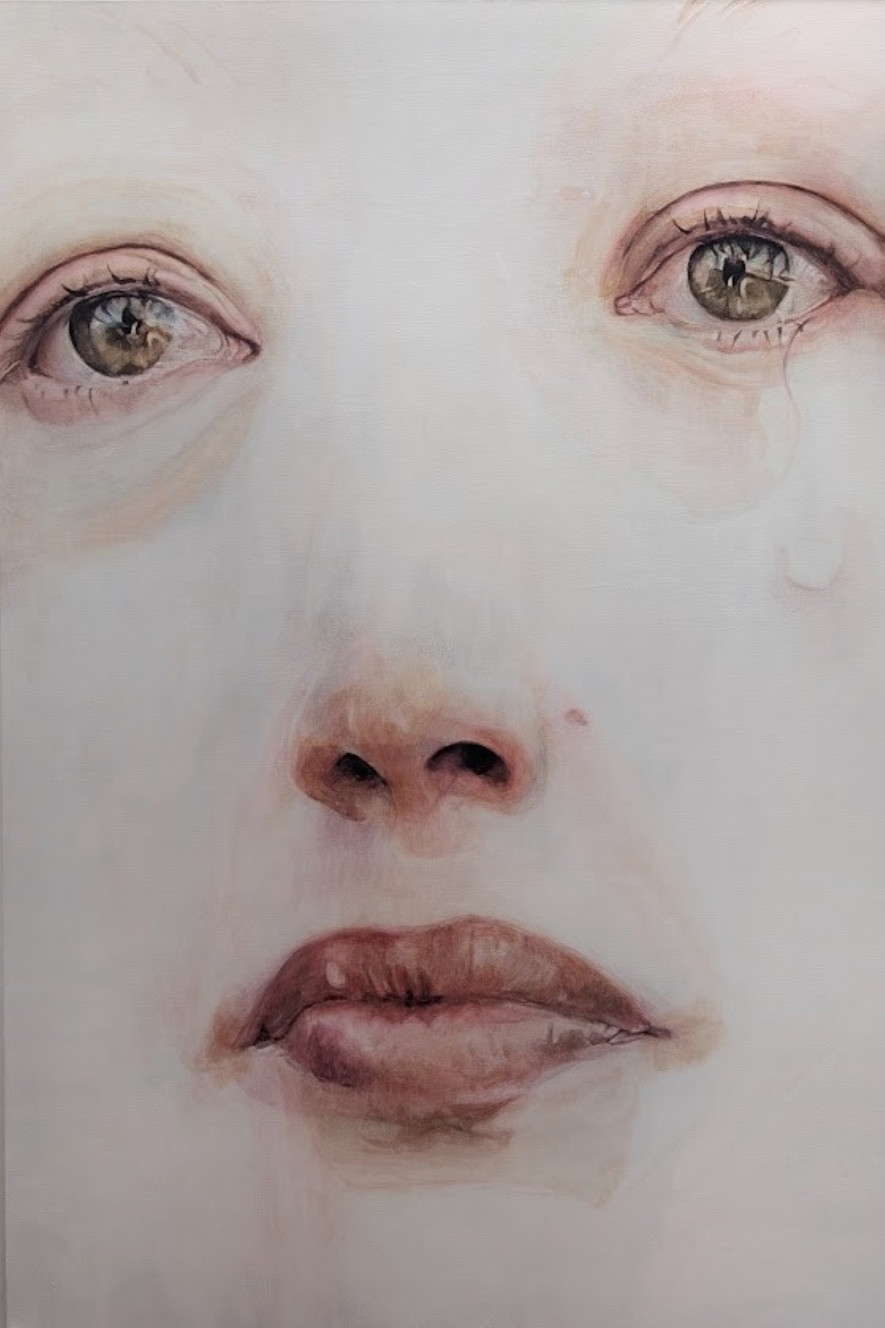 A watercolour painting depicting a close up view of a woman's face.  Her skin is unnaturally pale, and a single tear has fallen from her right eye.