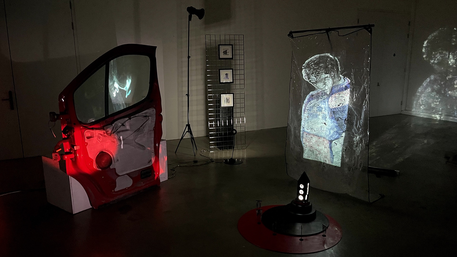An installation in a dark room featuring a light projection of a matador drawing.