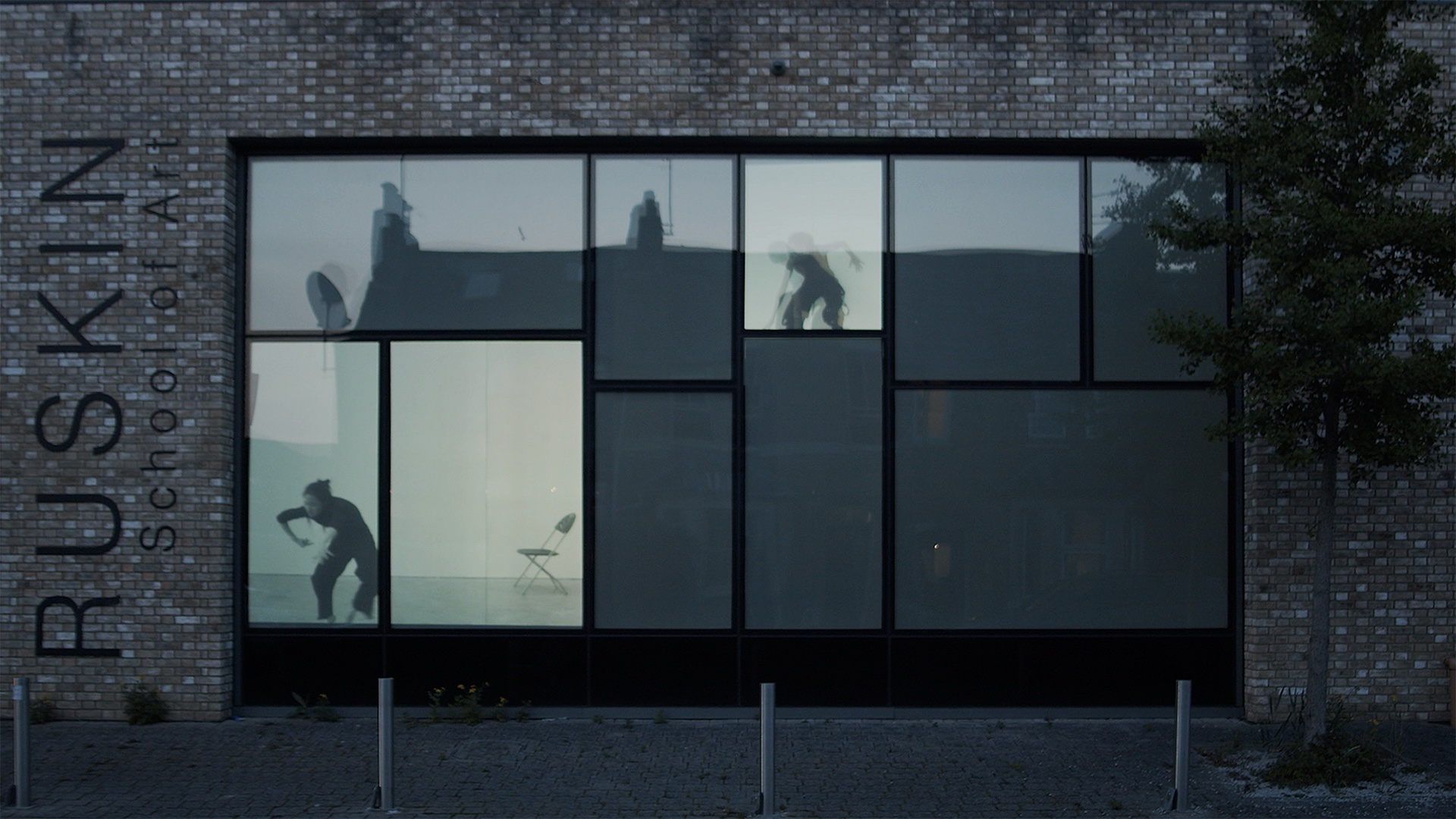 Split-screen film projected on the windows of the Ruskin's Bullingdon Road studio. Anonymous users move through each window, or 'chat-room', to find and doxx TOM, the digital pirate who has invaded their space. 
