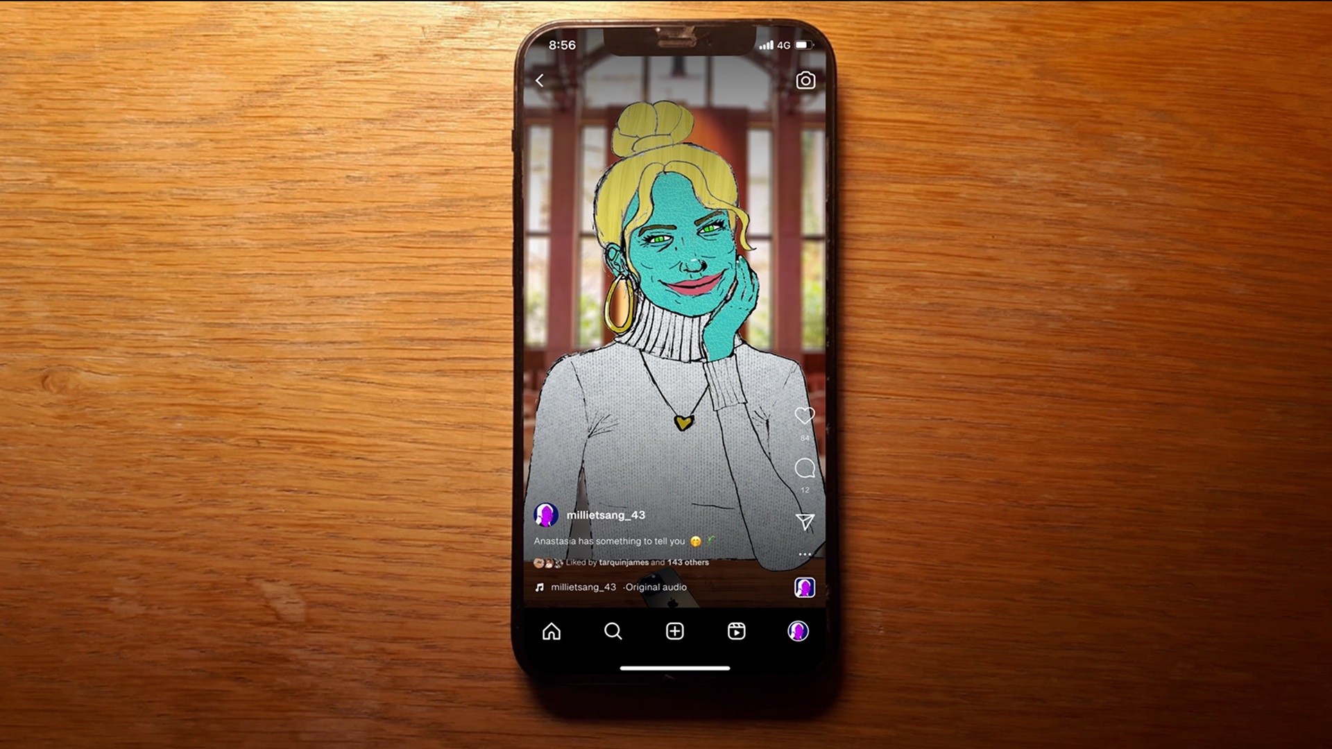 Still image of an overhead view of an iPhone on a wooden desk. The phone is open on an Instagram reel of Anastasia, a female-presenting being with teal scaly skin, green eyes and blonde hair. She is wearing a grey cashmere top with a gold heart locket. An 